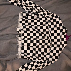 Woman’s cropped white and black checkered jean jacket